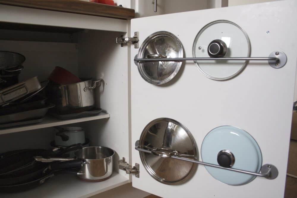 Ikea hack cabinet rail for pot covers. Source: apartmentapothecary.com