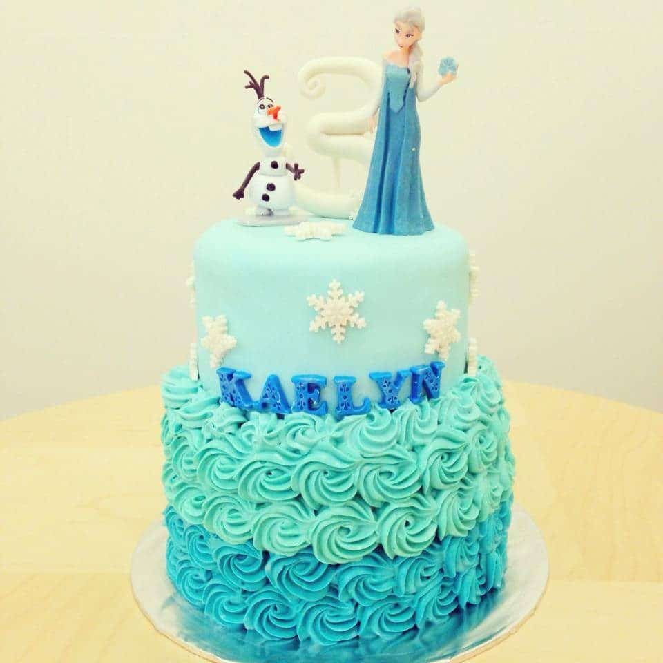 A two-tiered Frozen themed cake decorated with buttercream and fondant. Little House of Dreams. Source