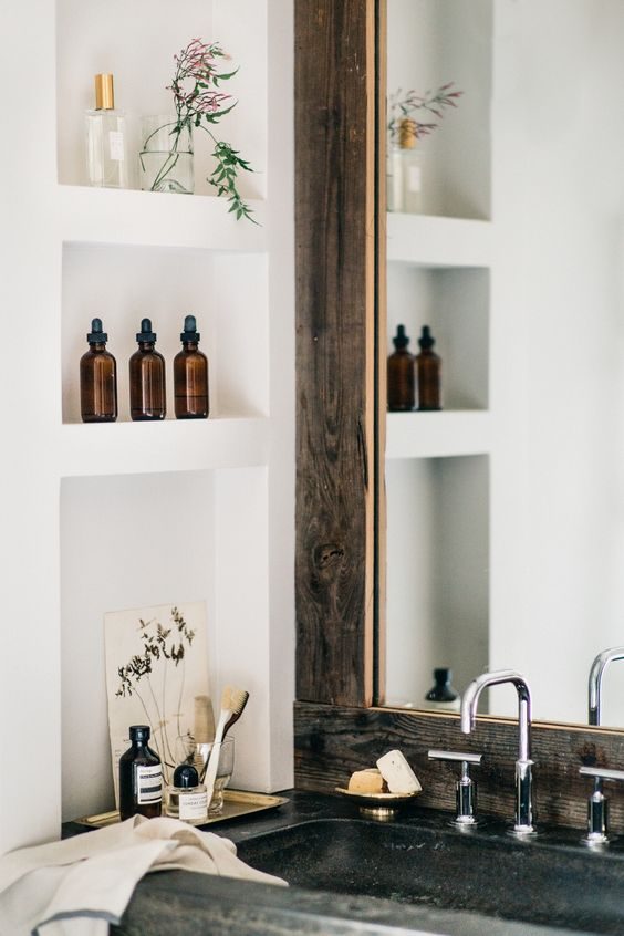 White cubby holes matched with distressed wood mirror frame