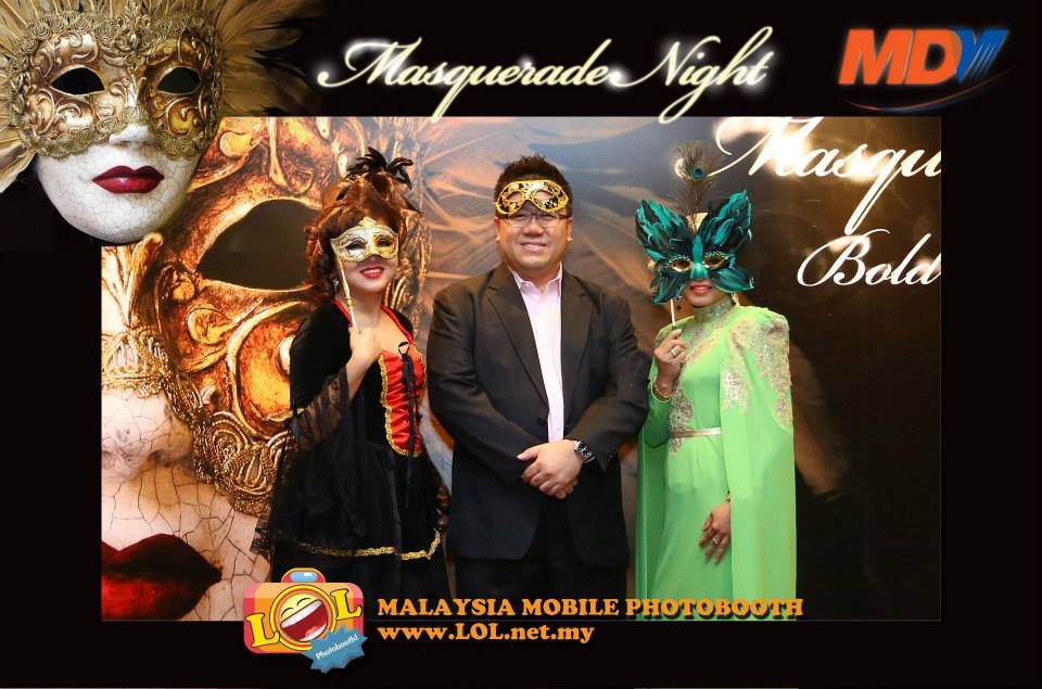 Masquerade-themed backdrop with matching props and digital frame
