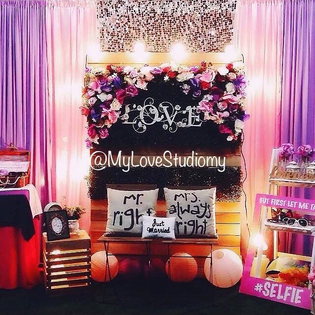 Lilac-themed backdrop using wooden pallet with flower arrangement and wooden bench