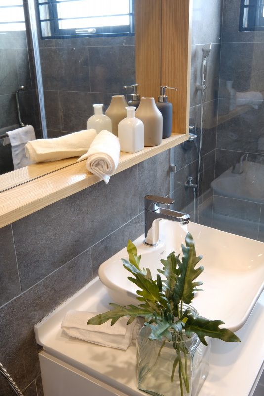 Renovated bathroom with framed mirror and counter