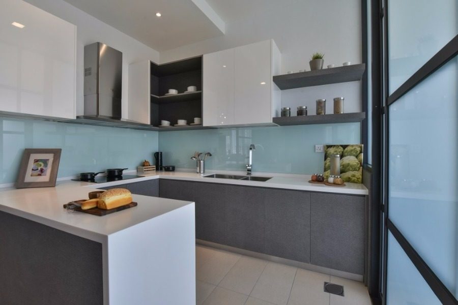 Above: Frosted glass doors separate the dry and wet kitchen for this terrace house in Kajang East