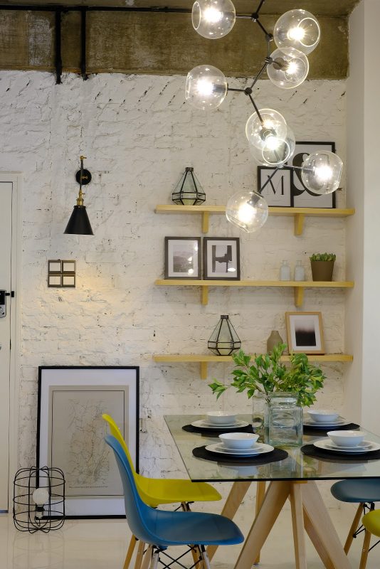 Above: Painted bare bricks with open shelving in blue, white and yellow theme