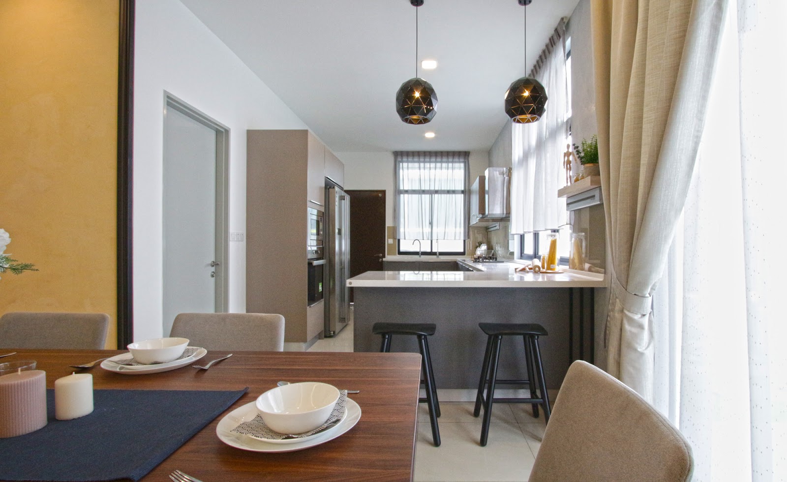 Kitchen with bar-stool counter with hanging pendant lights.