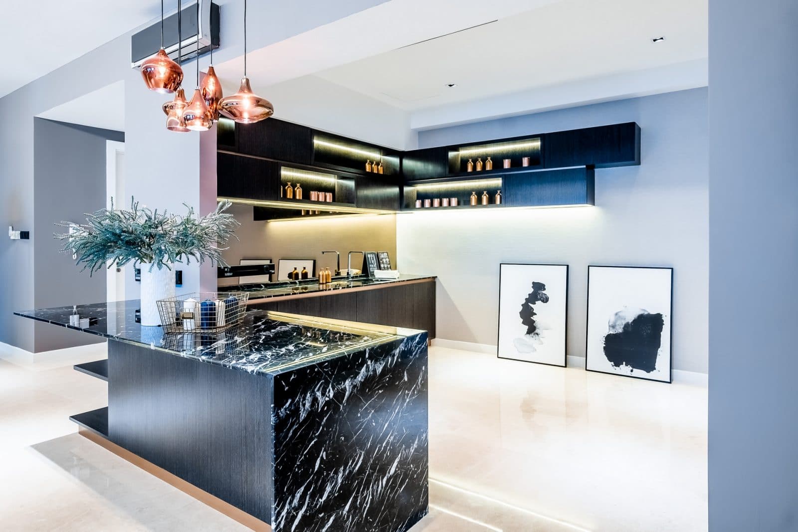 Above: Spanish marble kitchen countertop with a distinct “veiny” look. The copper lights above give the kitchen area a warm look.