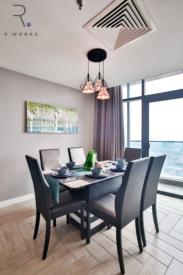 Dark brown furniture in the dining area with an industrial decorative lamp