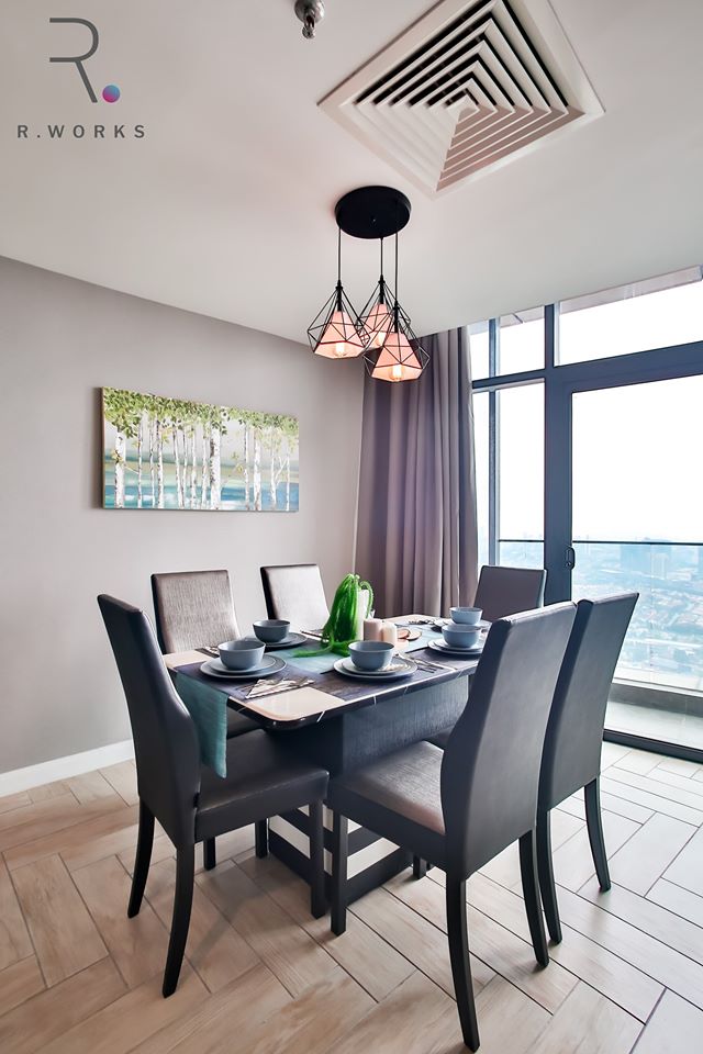 Dark brown furniture in the dining area with an industrial decorative lamp 