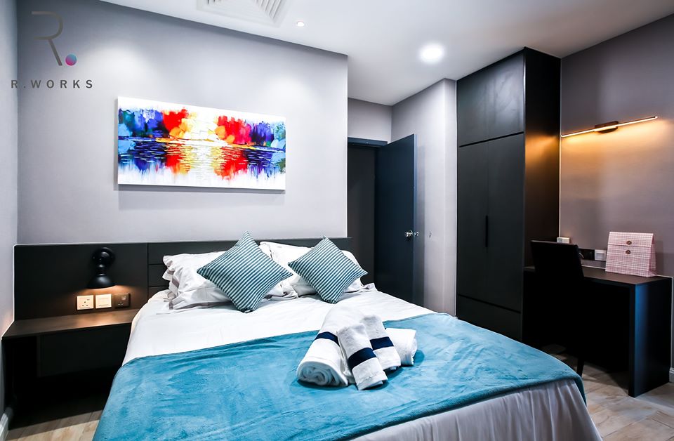 Striking blue and red accents in the first bedroom at Empire City, Damansara