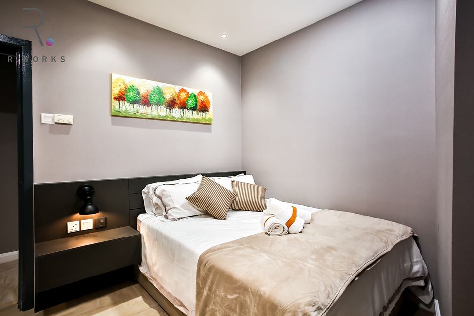 The second bedroom in warmer accent colours at Empire City, Damansara