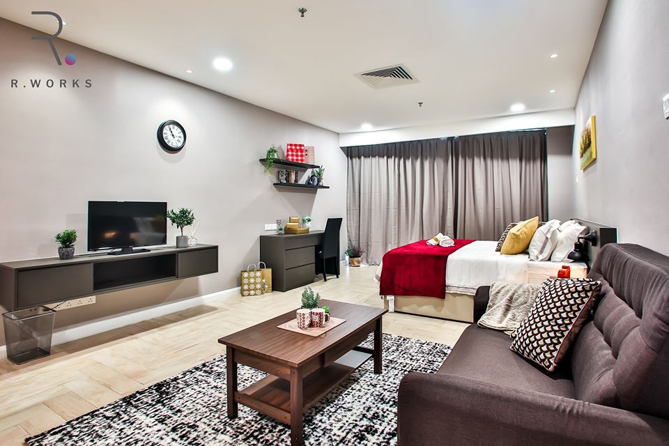 Interior of studio unit with red accents in Empire City, Damansara