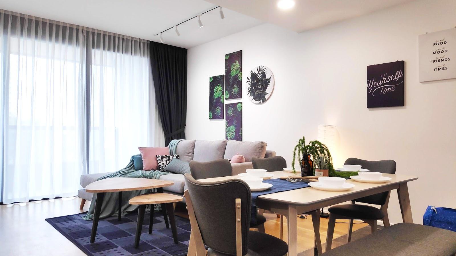 View of living and dining areas decorated in blue and purple
