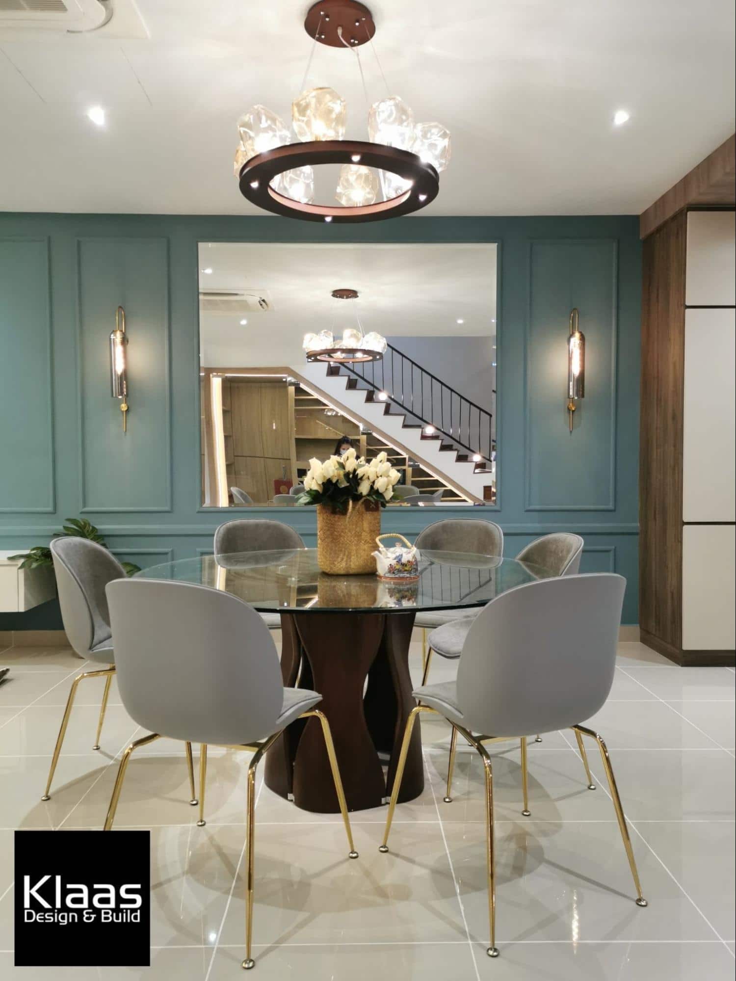 Close up of brightly lit dining room with turquoise feature wall 