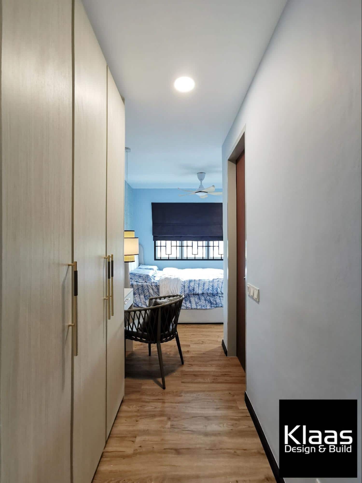 Wooden laminate wardrobe in blue bedroom