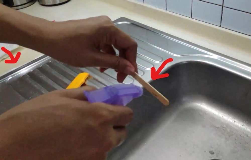 Spray some soapy water on the ice cream stick and along the newly-sealed edge