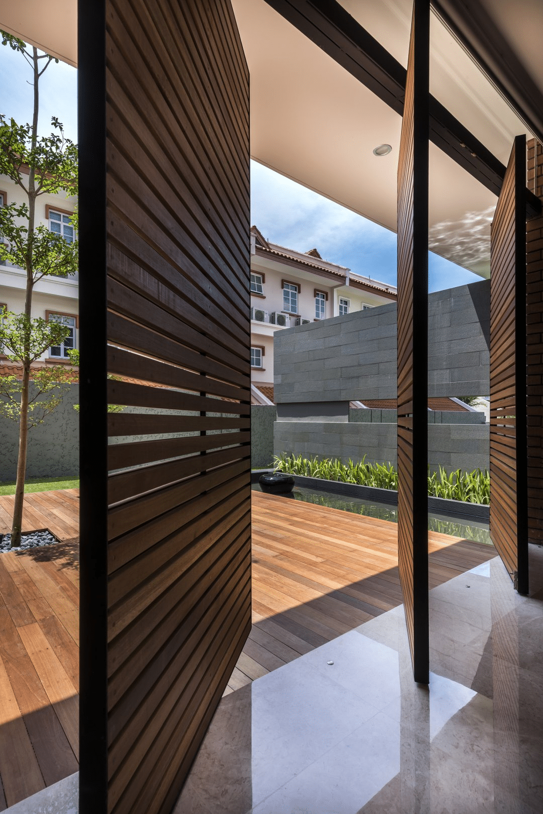 Wooden pivot doors to the backyard 