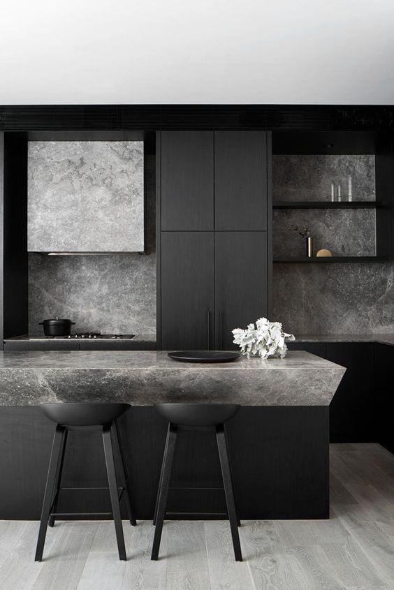 Black kitchen built-ins with marble counter tops and backsplash 