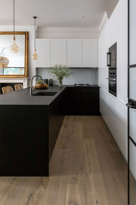 Black kitchen counter with light contemporary fixtures and decoration