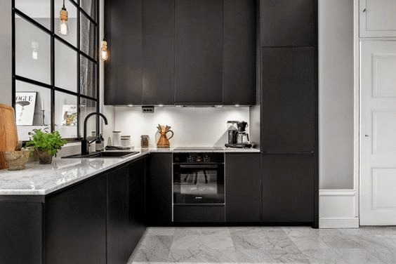 Sleek black kitchen cabinetry with a large window view into the living area