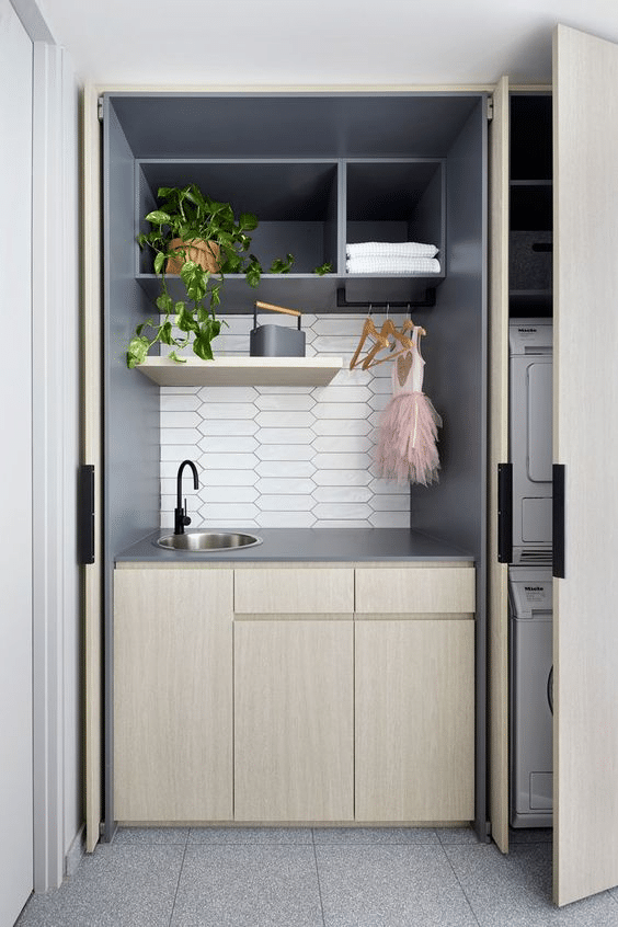 Modern hidden laundry area with eclectic natural elements 