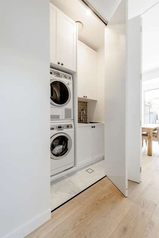 White laundry nook with full cabinets
