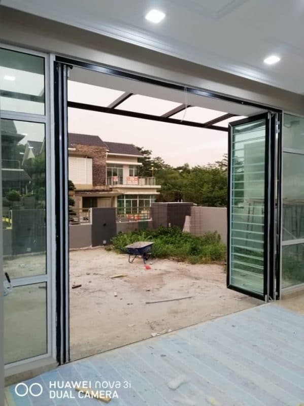Above: Folding door with integrated security grille at the terrace house driveway by Firstway Glass & Aluminum