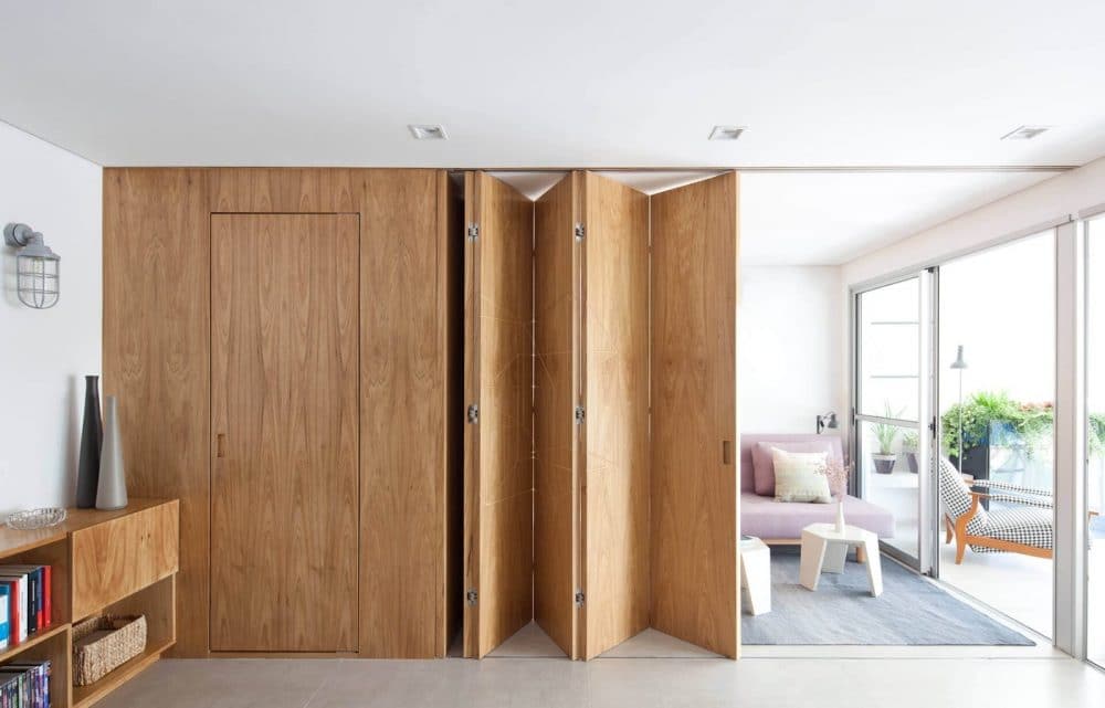 wood folding door divides the living and dining areas