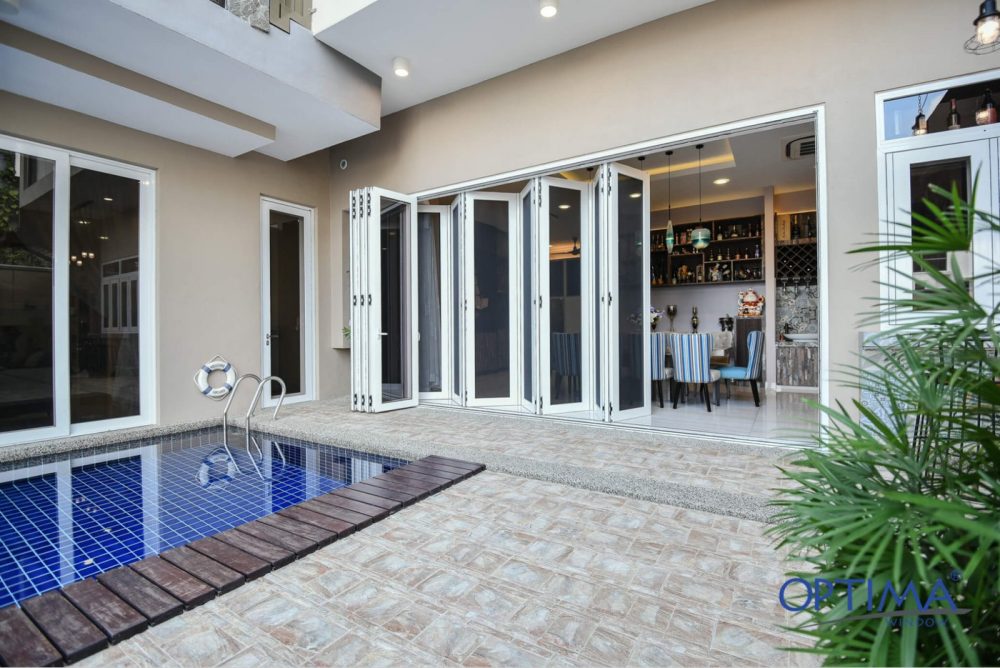 white frame folding door that opens out to pool area