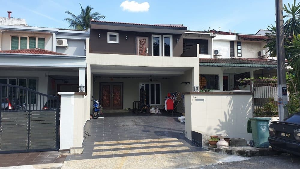 After renovation. The front porch and facade has been rebuilt to give more overhang, and the lawn has been tiled over to create two parking spaces. Works done my MTech Construction