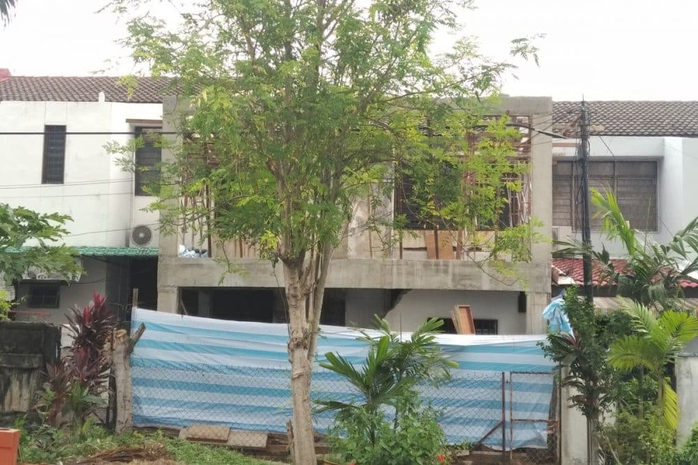 Above: The backyard of the same house was also extended to add more rooms and extend the kitchen